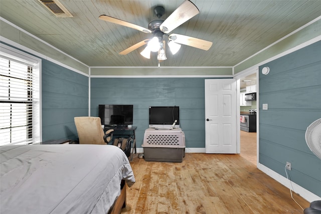 bedroom featuring ceiling fan, wooden ceiling, light hardwood / wood-style floors, wooden walls, and ornamental molding