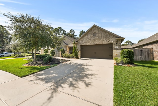 view of front of home featuring a garage and a front lawn