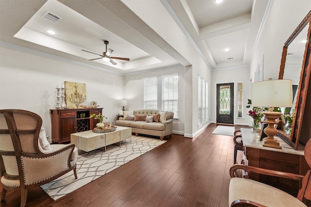 interior space featuring ceiling fan, wood-type flooring, ornamental molding, and a tray ceiling