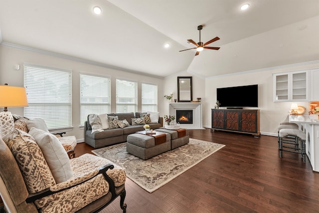 living room with dark hardwood / wood-style floors, ceiling fan, crown molding, and vaulted ceiling