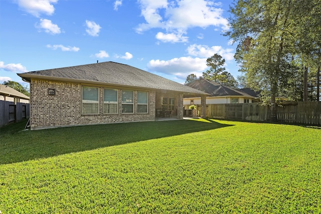 rear view of house with a yard and a patio area