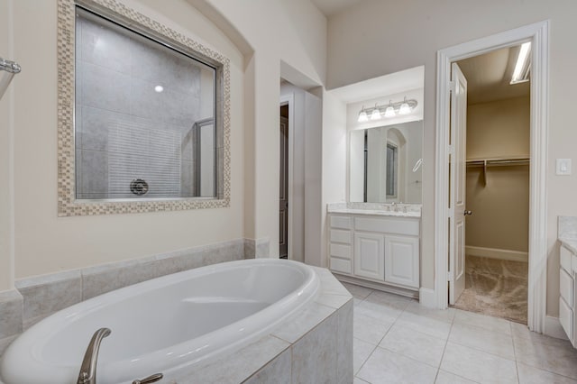 bathroom with tile patterned flooring, shower with separate bathtub, and vanity