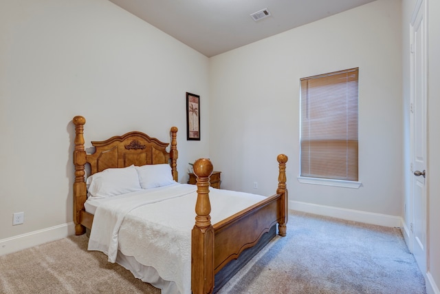 bedroom featuring light colored carpet