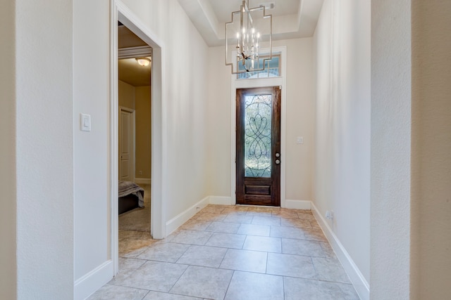 tiled foyer entrance with a chandelier