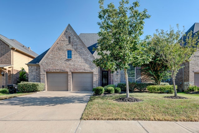 view of front of home with a front lawn and a garage