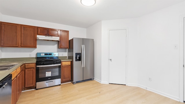 kitchen featuring light wood-type flooring and appliances with stainless steel finishes