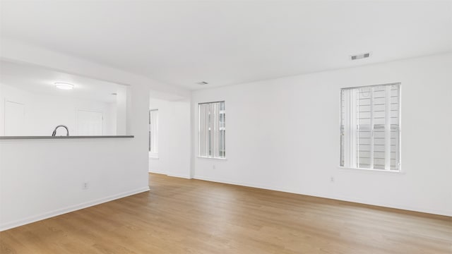 unfurnished living room with light hardwood / wood-style flooring