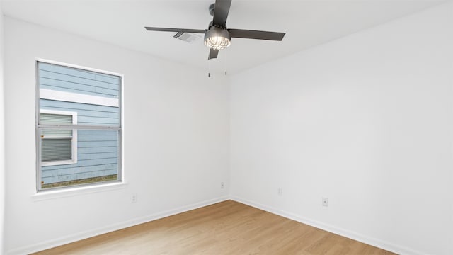 empty room with ceiling fan and light hardwood / wood-style floors