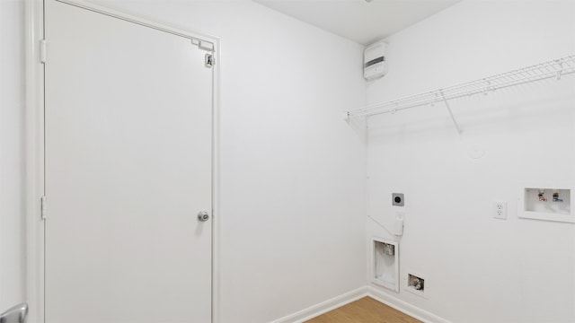 washroom with washer hookup, light hardwood / wood-style floors, and electric dryer hookup