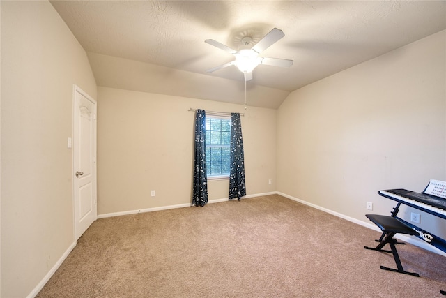 unfurnished room with ceiling fan, vaulted ceiling, and carpet floors