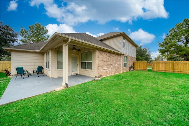 back of house featuring ceiling fan, a patio, and a yard