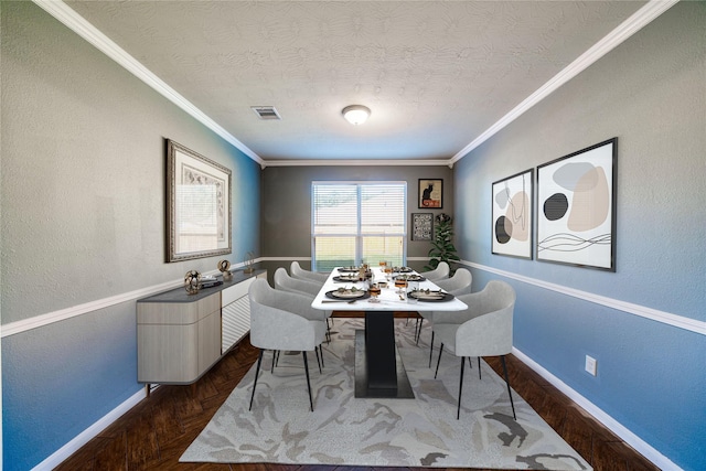 dining room with a textured ceiling, ornamental molding, and parquet floors