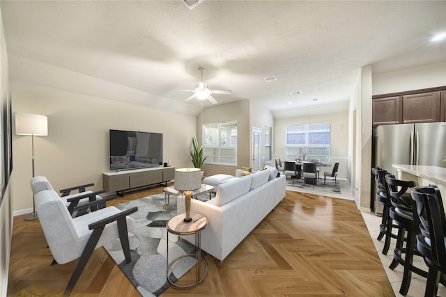 living room with ceiling fan and light parquet floors