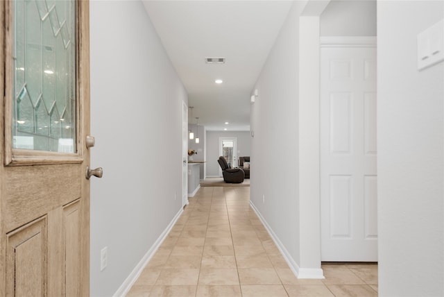 hallway featuring light tile patterned floors