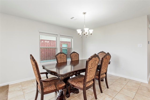 dining area with light tile patterned flooring and a notable chandelier