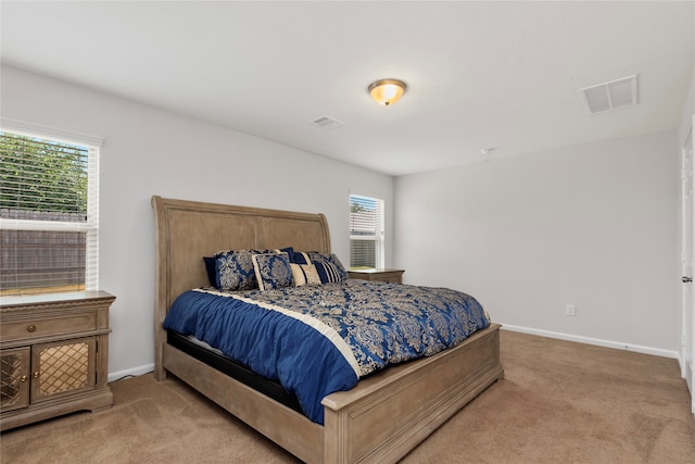 carpeted bedroom featuring multiple windows