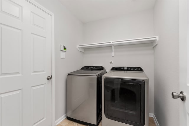 washroom featuring light tile patterned floors and separate washer and dryer