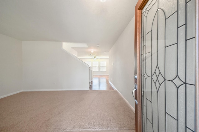 carpeted entrance foyer featuring ceiling fan