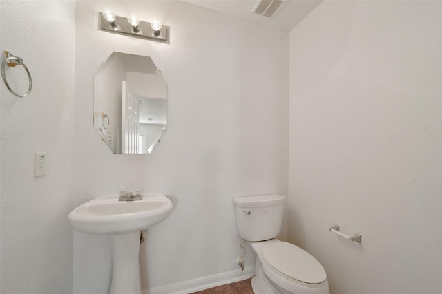 bathroom featuring toilet and sink