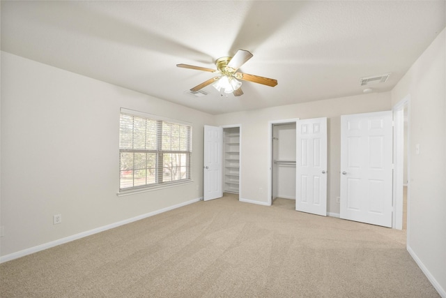 unfurnished bedroom featuring ceiling fan and light colored carpet