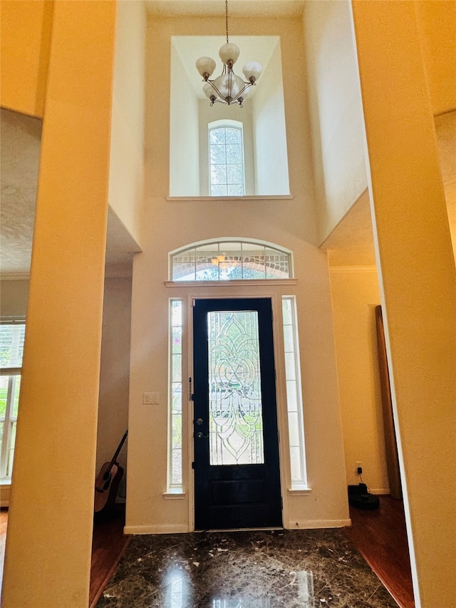 entrance foyer with plenty of natural light and an inviting chandelier