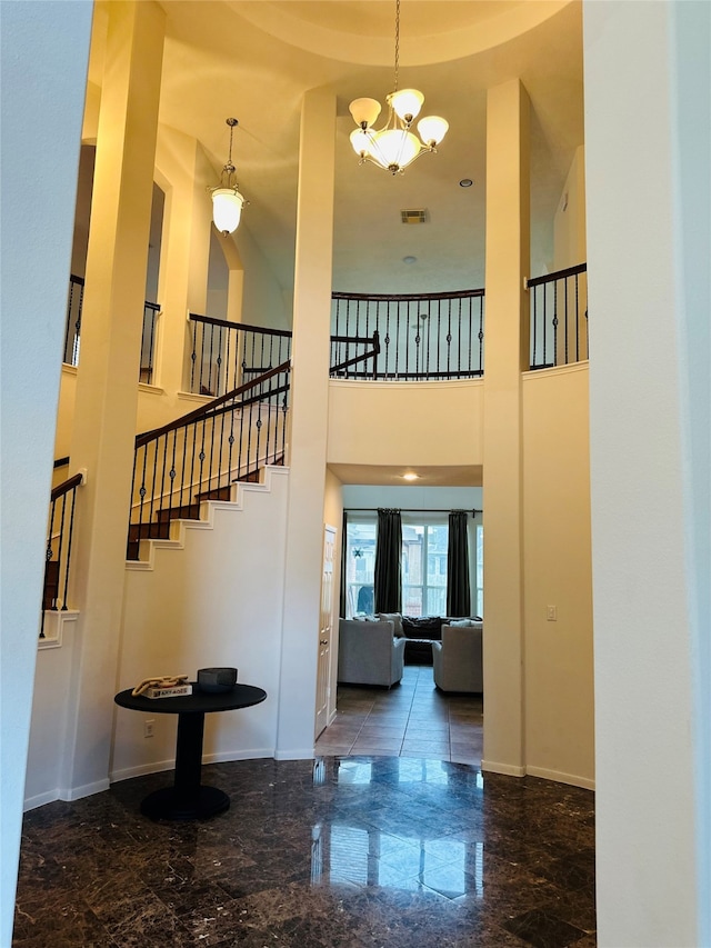 entrance foyer with a towering ceiling and an inviting chandelier