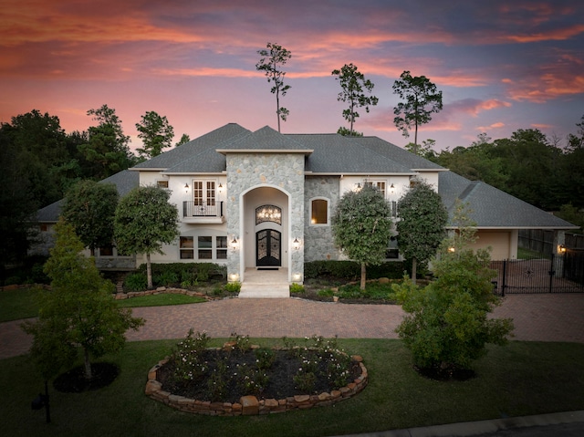 view of front facade with french doors and a balcony