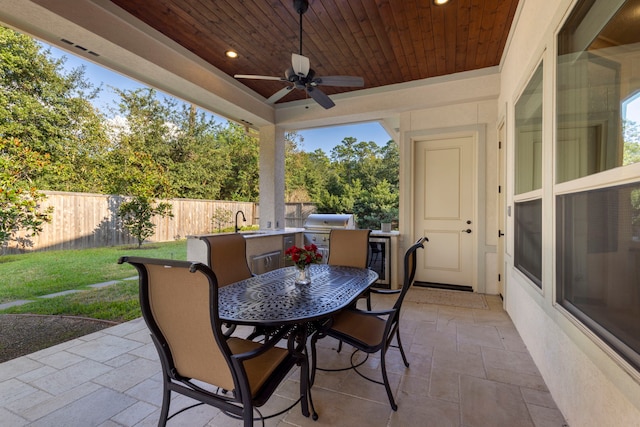 view of patio with ceiling fan, beverage cooler, sink, exterior kitchen, and grilling area