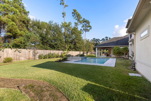 view of pool with a patio area and a yard