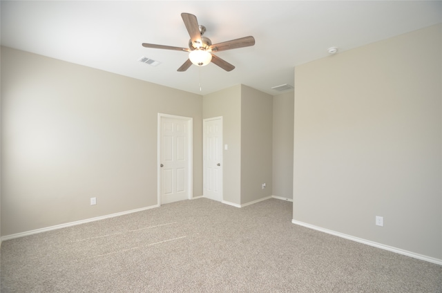 unfurnished room with ceiling fan and light carpet