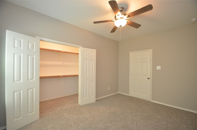 unfurnished bedroom featuring ceiling fan, light colored carpet, and a closet