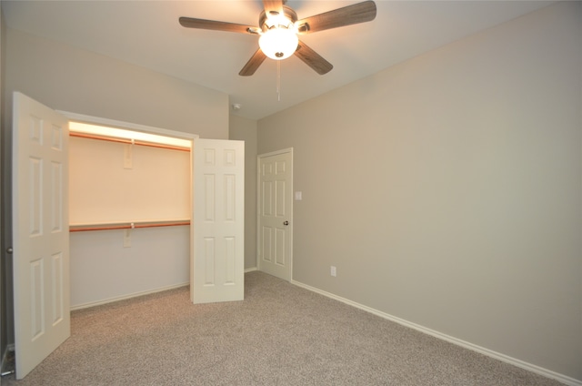 unfurnished bedroom with carpet flooring, ceiling fan, and a closet