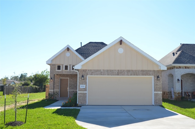 view of front of property featuring a front lawn and a garage