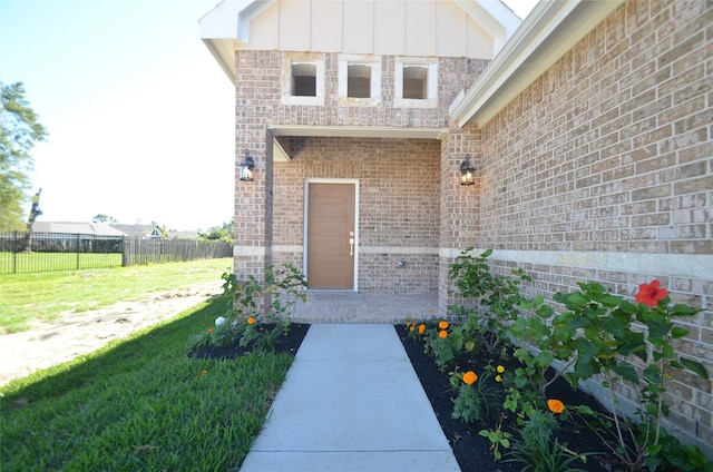 doorway to property with a lawn