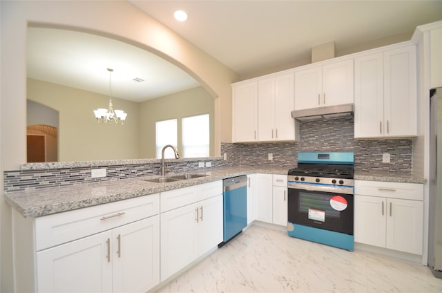 kitchen featuring tasteful backsplash, stainless steel appliances, sink, a chandelier, and white cabinetry