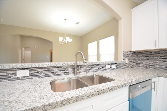 kitchen featuring white cabinets, tasteful backsplash, stainless steel dishwasher, and sink