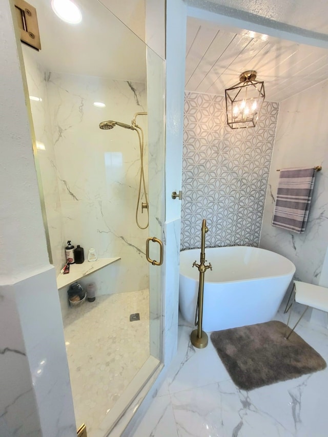 bathroom featuring separate shower and tub and a chandelier