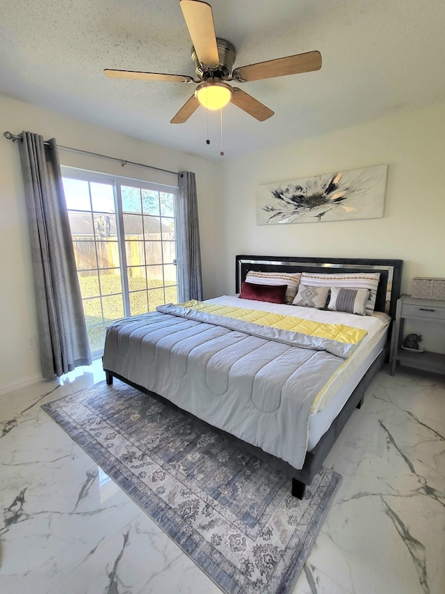 bedroom featuring ceiling fan and a textured ceiling