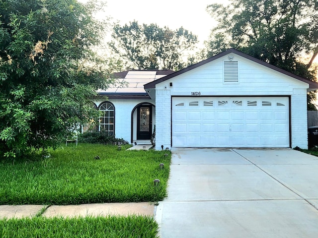 single story home featuring a front yard and a garage