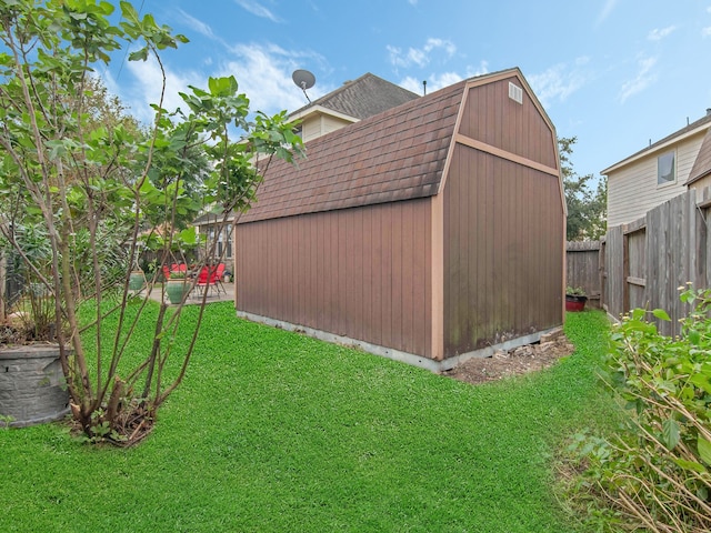 view of outbuilding with a yard