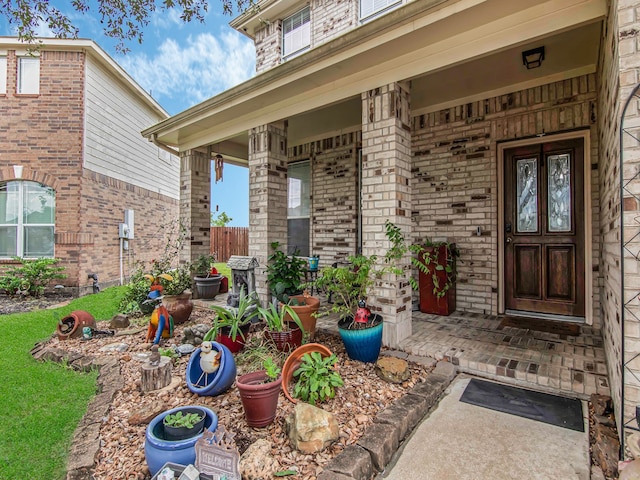 view of exterior entry featuring covered porch