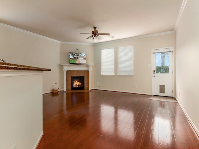 unfurnished living room featuring ceiling fan, dark hardwood / wood-style flooring, and crown molding