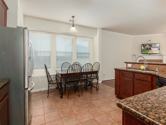 kitchen with pendant lighting, crown molding, sink, and appliances with stainless steel finishes