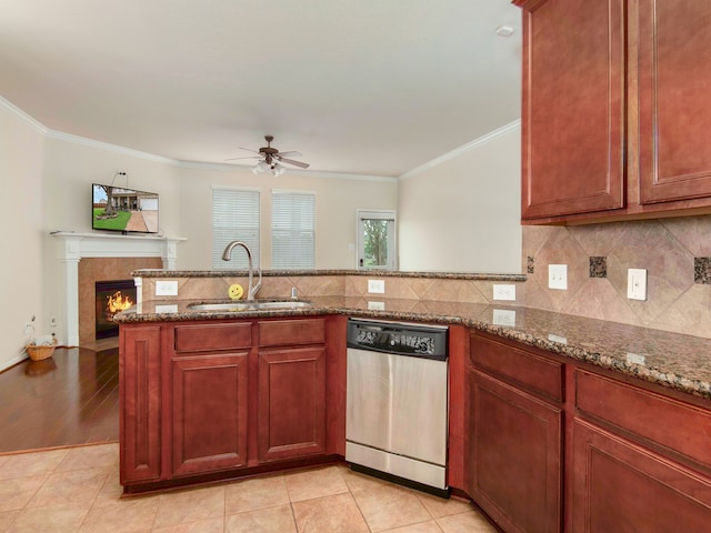 kitchen featuring kitchen peninsula, ornamental molding, sink, stone countertops, and dishwasher