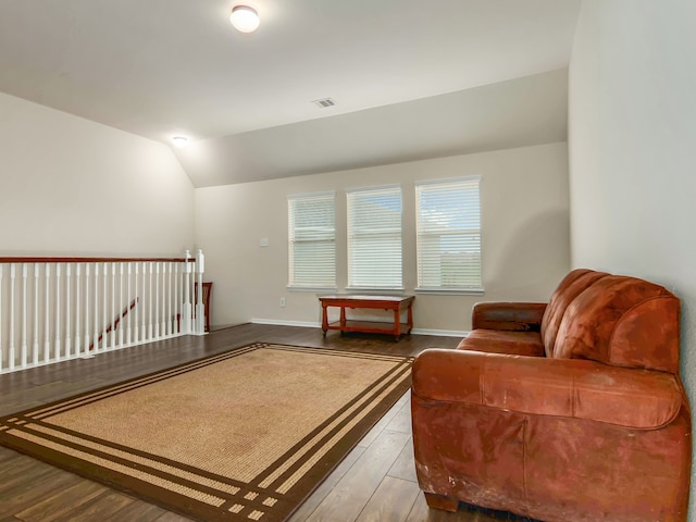 living area with lofted ceiling and hardwood / wood-style flooring