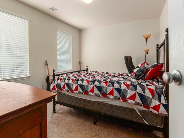 bedroom featuring light colored carpet