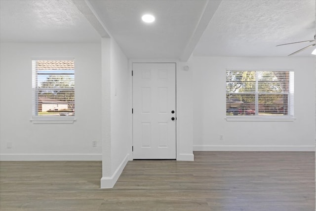 entryway with hardwood / wood-style floors, a textured ceiling, and ceiling fan