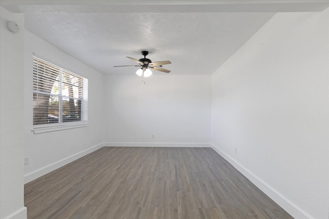 spare room featuring a textured ceiling, ceiling fan, and dark wood-type flooring