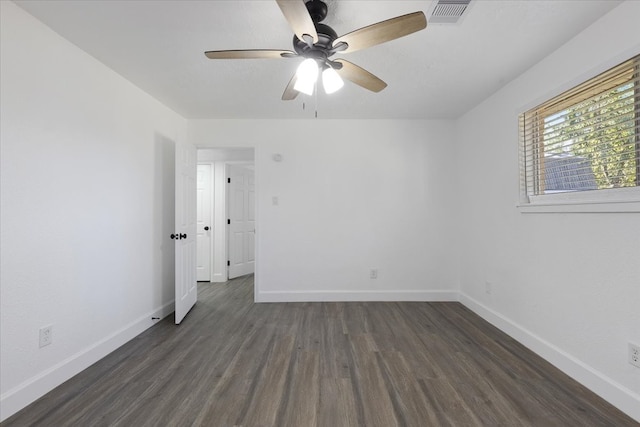 empty room featuring ceiling fan and dark wood-type flooring