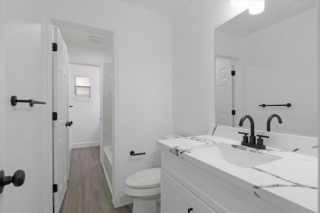 bathroom featuring hardwood / wood-style floors, vanity, and toilet